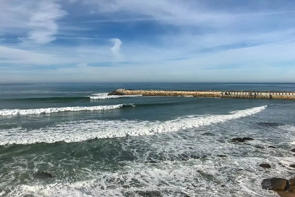 Surfing in the harbour of Ericeira at Praia dos Pescadores