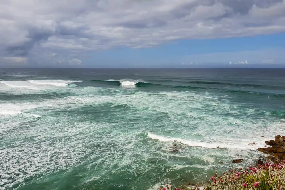 Wave breaking both left and right at Praia do Magoito