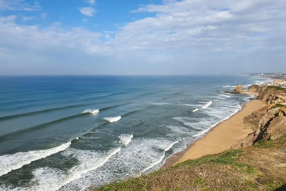 Wave breaking in front of Praia das Amoeiras with Santa Cruz in the background